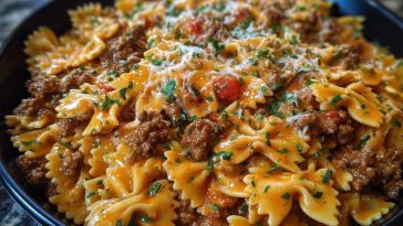 Cajun Cream Cheese Alfredo Bowties with Spiced Ground Beef Turn up the comfort with this flavor-packed Cajun Cream Cheese Alfredo Bowties with Spiced Ground Beef. This dish is all about indulgence: tender bowtie pasta enveloped in a rich, creamy cheese sauce, kicked up with Cajun spices and paired with hearty, well-seasoned beef. Whether it’s a cozy weeknight dinner or a crowd-pleasing meal for guests, this skillet creation delivers bold Southern flair with every bite. The best part? It all comes together in one pan. That means less mess and more flavor mingling between the pasta, meat, and cheesy sauce. It’s savory, creamy, and just the right amount of spicy—a guaranteed repeat recipe in your kitchen. ## Preparation Phase & Tools to Use (Essential Tools and Equipment, Plus Their Importance) Before diving in, make sure your kitchen is prepped with the right tools: * **Large Skillet or Sauté Pan**: This is the star of your setup. A wide skillet ensures even cooking and room to toss the pasta and sauce together without crowding. * **Wooden Spoon or Silicone Spatula**: Ideal for stirring the beef as it browns and for gently folding the creamy sauce into the pasta. * **Medium Pot**: Used to cook the bowtie pasta until al dente. It should be large enough for boiling without spillover. * **Colander**: Necessary for draining the pasta, especially if you're not cooking it directly in the skillet. * **Microplane or Cheese Grater**: If you’re using freshly shredded cheese (recommended!), this tool helps achieve a smooth melt. Setting yourself up with these essentials will make the cooking process smooth, efficient, and more enjoyable. --- ## Ingredients for the Cajun Cream Cheese Alfredo Bowties with Spiced Ground Beef Each ingredient in this bold pasta dish plays a crucial role in building a deeply satisfying flavor: * **Bowtie Pasta (Farfalle)**: The perfect pasta shape to catch and hold onto the creamy sauce in every groove. * **Ground Beef**: Hearty and flavorful, it gives the dish its richness and comforting bite. * **Cream Cheese**: Adds tang and luxurious creaminess to balance the Cajun spices. * **Heavy Cream**: Essential for creating a silky, indulgent Alfredo base. * **Shredded Cheddar & Mozzarella Cheese**: This combo offers meltability and flavor depth. * **Cajun Seasoning**: The heart of the flavor—smoky, spicy, and bold. * **Garlic (Minced)**: Adds a warm, aromatic backbone to the beef and sauce. * **Onion Powder & Paprika**: Boosts the savoriness and enhances the color of the sauce. * **Butter**: Used to enrich the base and help melt the cheeses smoothly. * **Fresh Parsley (optional)**: For a touch of color and freshness at the end. --- ## How To Make the Cajun Cream Cheese Alfredo Bowties with Spiced Ground Beef ### Step 1: Brown the Beef In a large skillet over medium-high heat, cook the ground beef until fully browned. Break it into crumbles and season it with half of the Cajun seasoning. Drain excess fat if needed. ### Step 2: Boil the Pasta While the beef cooks, bring a medium pot of salted water to a boil. Cook the bowtie pasta until al dente, then drain and set aside. ### Step 3: Make the Creamy Base Reduce the skillet to medium heat. Add butter and minced garlic to the beef. Sauté for 1-2 minutes, then stir in the cream cheese until melted. ### Step 4: Create the Alfredo Sauce Pour in the heavy cream and sprinkle in the remaining Cajun seasoning, onion powder, and paprika. Stir gently, letting it simmer for a few minutes until the sauce thickens slightly. ### Step 5: Combine Pasta and Sauce Add the cooked bowtie pasta into the skillet and toss to coat it thoroughly in the sauce. Sprinkle in the shredded cheddar and mozzarella, stirring until melted and gooey. ### Step 6: Final Touch Turn off the heat and top with a little extra cheese if desired. Garnish with chopped parsley before serving for a vibrant finish. --- ## Best Ways to Serve and Store This Creamy Cajun Pasta This pasta is at its absolute best when served hot and fresh out of the skillet. The cheeses are still melty, the sauce creamy, and the bowties tender but firm. Pair it with a slice of crusty garlic bread or a crisp green salad to round out your meal. A drizzle of hot sauce or a squeeze of lemon can add extra zing for spice-lovers. For storing leftovers, let the pasta cool completely and transfer to an airtight container. It will keep in the refrigerator for up to 3 days. When reheating, add a splash of cream or milk to restore the sauce's smooth texture. Avoid microwaving for too long to prevent the cheese from separating. ## Frequently Asked Questions ### What can I substitute for ground beef? Ground turkey, chicken, or even plant-based meat alternatives work well. Just season them generously to maintain that Cajun punch. ### Is this dish very spicy? That depends on your Cajun seasoning blend. Start with less if you're spice-sensitive, and add more to taste. ### Can I make it ahead of time? You can prep the beef and sauce a day ahead. Cook the pasta fresh and combine everything when you're ready to serve. ### Does cream cheese belong in Alfredo? Traditionally, no—but in this version, cream cheese adds a velvety tang that thickens and modernizes the sauce beautifully. ### Can I use a different type of pasta? Absolutely! Penne, rotini, or shells will also hold the creamy sauce well. ### What kind of cheddar is best? Sharp cheddar brings bold flavor, but a mild or medium cheddar will melt smoother. A mix of both is ideal. --- ## Want More Pasta Dinner Ideas? If this Cajun Cream Cheese Alfredo Bowties with Spiced Ground Beef won you over, here are some other irresistible pasta favorites from Life With Olivia: * [Creamy Garlic Butter Chicken Rotini in Parmesan Sauce](https://lifewitholivia.com/creamy-garlic-butter-chicken-rotini-in-parmesan-sauce/) – a silky, comforting dinner option. * [Spicy Cajun Garlic Butter Sausage Pasta](https://lifewitholivia.com/spicy-cajun-garlic-butter-sausage-pasta/) – perfect if you love heat and bold sausage flavor. * [Cheesy Garlic Chicken and Broccoli Pasta](https://lifewitholivia.com/cheesy-garlic-chicken-and-broccoli-pasta/) – for a family-friendly classic with veggies built in. * [Creamy Spicy Buffalo Ranch Pasta](https://lifewitholivia.com/creamy-spicy-buffalo-ranch-pasta/) – a fiery twist with a ranchy kick. * [Beef and Bowtie Pasta with Alfredo Sauce](https://lifewitholivia.com/beef-and-bowtie-pasta-with-alfredo-sauce/) – another rich, beefy bowtie favorite to bookmark. ## Save This Recipe for Later 📌 Save this recipe to your Pinterest dinner board so you can come back to it any time. And let me know in the comments how yours turned out. Did you add more spice? Swap in a different cheese? Maybe try it with shrimp? I love seeing how these recipes evolve in your kitchens. Share your thoughts, tweaks, or questions below—we’re all about building flavor together. For more daily recipe inspiration, follow along on my Pinterest: [Life With Olivia](https://www.pinterest.com/scherer29/) ---